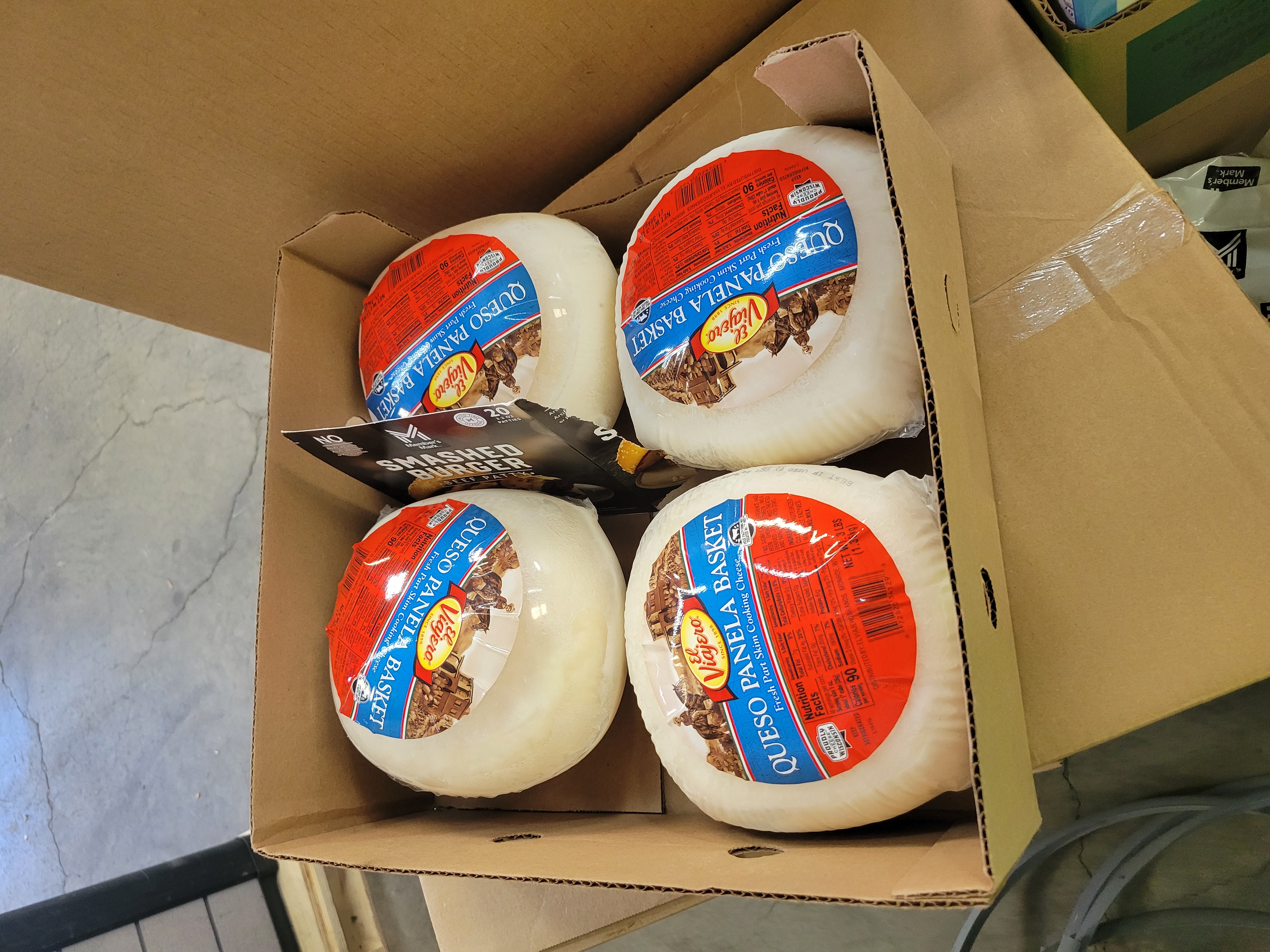 Cardboard box full of queso panela basket.